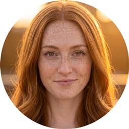 Rory Shea — smiling redhead with freckles at golden hour